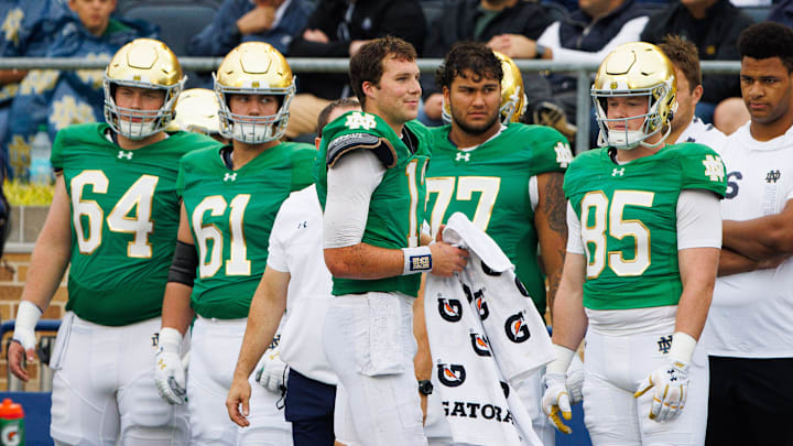Notre Dame quarterback Riley Leonard (13) sits out for a snap after being banged up on the previous play during a NCAA college football game between Notre Dame and Louisville at Notre Dame Stadium on Saturday, Sept. 28, 2024, in South Bend.