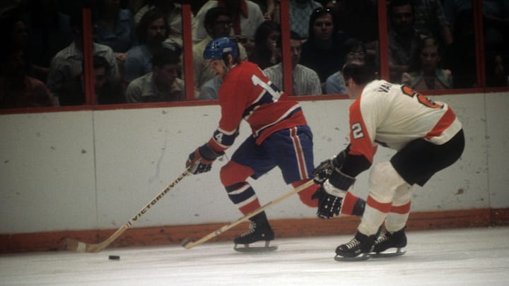 Ed Van Impe, defends Montreal Canadiens Rejean Houle