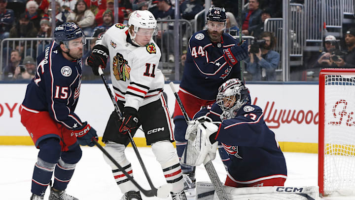 Feb 4, 2026; Columbus, Ohio, USA; Columbus Blue Jackets goalie Jet Greaves (73) makes a glove save as Chicago Blackhawks center Oliver Moore (11) looks for a rebound during the third period at Nationwide Arena. Mandatory Credit: Russell LaBounty-Imagn Images