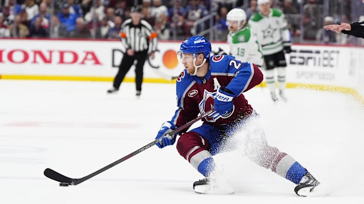 May 1, 2025; Denver, Colorado, USA; Colorado Avalanche center Nathan MacKinnon (29) controls the puck in the second period against the Dallas Stars in game six of the first round of the 2025 Stanley Cup Playoffs at Ball Arena. Mandatory Credit: Ron Chenoy-Imagn Images