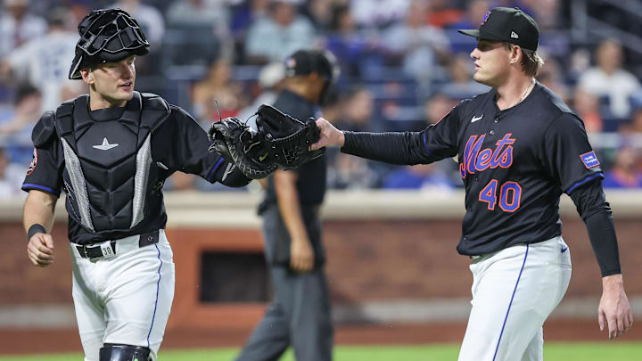 Jul 2, 2025; New York City, New York, USA; New York Mets catcher Hayden Senger (30) congratulates relief pitcher Blade Tidwell (40) after retiring the side in the fifth inning against the Milwaukee Brewers at Citi Field. Mandatory Credit: Wendell Cruz-Imagn Images