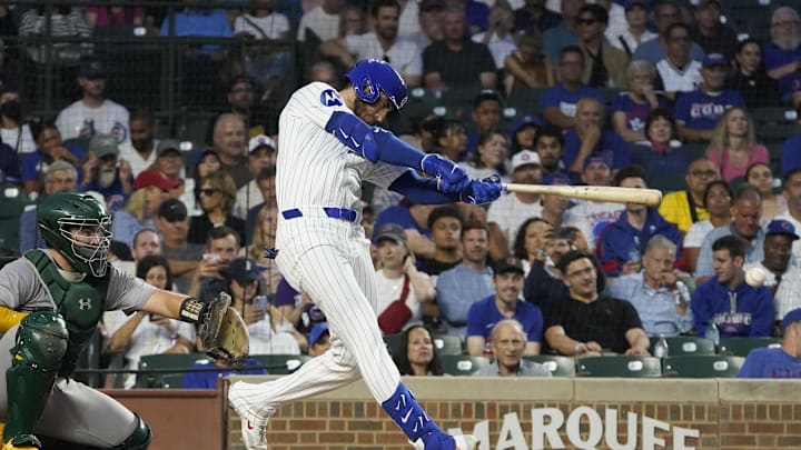 Sep 16, 2024; Chicago, Illinois, USA; Chicago Cubs outfielder Cody Bellinger (24) hits a single against the Oakland Athletics during the first inning at Wrigley Field. Mandatory Credit: David Banks-Imagn Images