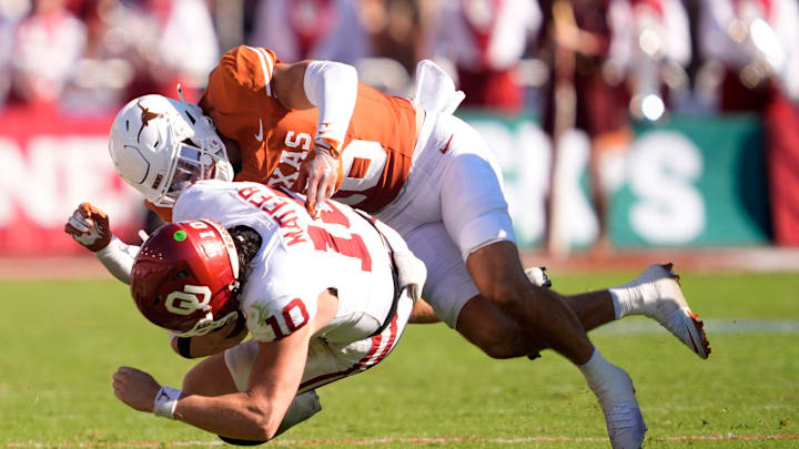 Texas Longhorns defensive back Michael Taaffe (16) tackles Oklahoma Sooners quarterback John Mateer (10) in the first half of the Red River Rivalry college football game between the University of Oklahoma Sooners and the Texas Longhorn at the Cotton Bowl Stadium in Dallas, Texas, Saturday, Oct. 11, 2025.