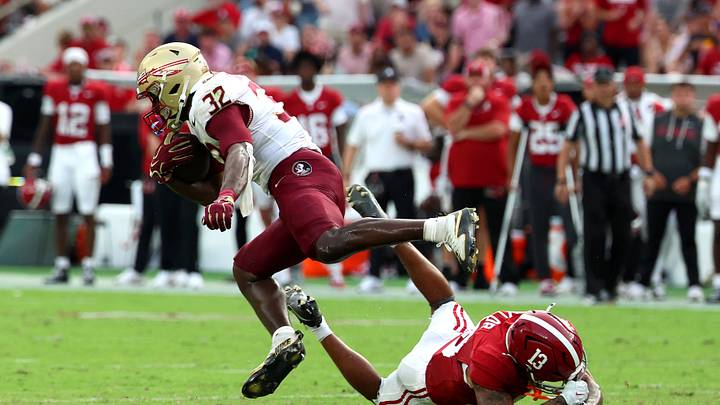 Sep 19, 2026; Tuscaloosa, Alabama, USA; Florida State Seminoles running back Ousmane Kromah (32) runs against Alabama Crimson Tide defensive back Ivan Taylor (13) during the second half at Saban Field at Bryant-Denny Stadium. Mandatory Credit: David Leong-Imagn Images Sep 19, 2026; Tuscaloosa, Alabama, USA; Florida State Seminoles running back Ousmane Kromah (32) runs against Alabama Crimson Tide defensive back Ivan Taylor (13) during the second half at Saban Field at Bryant-Denny Stadium. Mandatory Credit: David Leong-Imagn Images