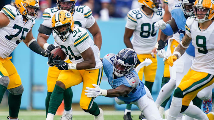 Green Bay Packers running back Emanuel Wilson (31) is stopped by Tennessee Titans linebacker Ernest Jones IV (53) during the second quarter at Nissan Stadium in Nashville, Tenn., Sunday, Sept. 22, 2024.