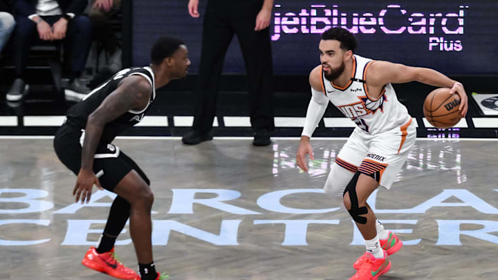 Phoenix Suns guard Tyus Jones sets the play while being defended by Brooklyn Nets forward Dariq Whitehead. Phoenix Suns guard Tyus Jones sets the play while being defended by Brooklyn Nets forward Dariq Whitehead.