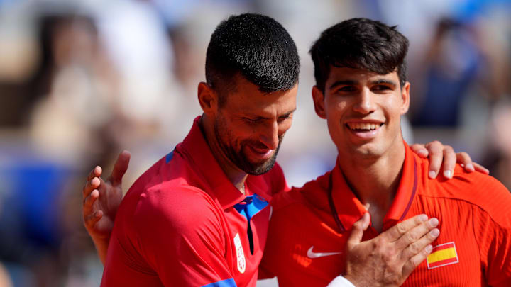 Aug 4, 2024; Paris, France; Novak Djokovic (SRB) greets Carlos Alcaraz (ESP) after winning the men’s singles gold medal match during the Paris 2024 Olympic Summer Games at Stade Roland Garros. Mandatory Credit: Amber Searls-Imagn Images Aug 4, 2024; Paris, France; Novak Djokovic (SRB) greets Carlos Alcaraz (ESP) after winning the men’s singles gold medal match during the Paris 2024 Olympic Summer Games at Stade Roland Garros. Mandatory Credit: Amber Searls-Imagn Images