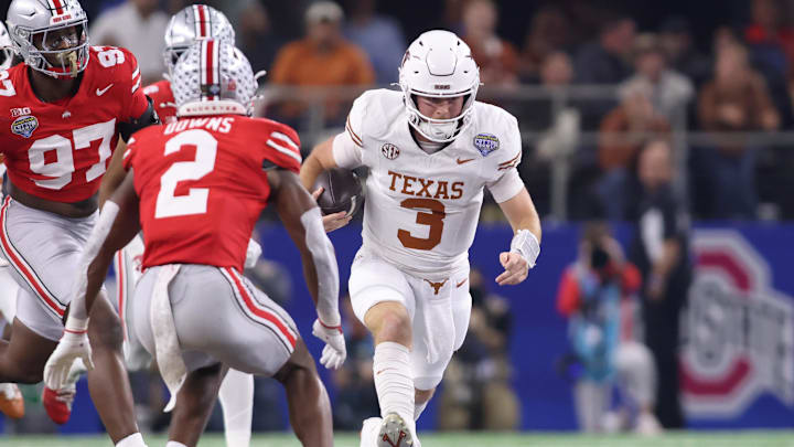 Jan 10, 2025; Arlington, Texas, USA; Texas Longhorns quarterback Quinn Ewers (3) runs against Ohio State Buckeyes safety Caleb Downs (2) during the second quarter of the College Football Playoff semifinal in the Cotton Bowl at AT&T Stadium. Mandatory Credit: Tim Heitman-Imagn Images