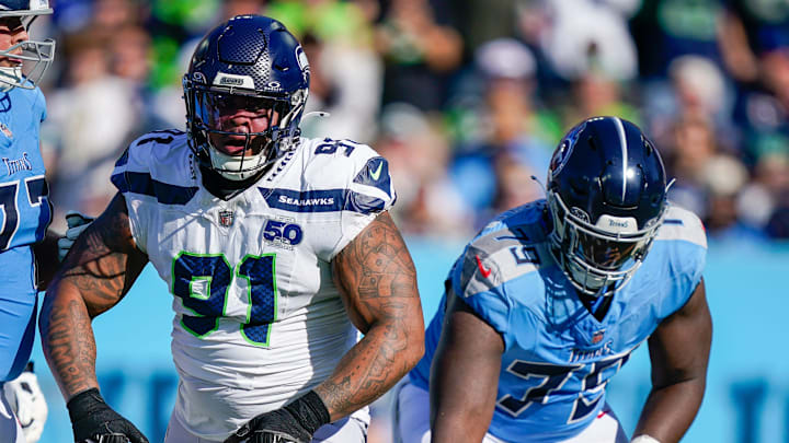 Seattle Seahawks defensive tackle Byron Murphy II (91) celebrates a sack of Tennessee Titans quarterback Cam Ward (1) during the second quarter at Nissan Stadium in Nashville, Tenn., Sunday, Nov. 23, 2025.