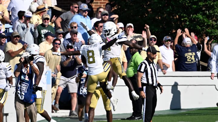 Oct 12, 2024; Chapel Hill, North Carolina, USA; Georgia Tech Yellow Jackets running back Jamal Haynes (11) celebrates with wide receiver Malik Rutherford (8) after scoring a touchdown in the last minute of the fourth quarter at Kenan Memorial Stadium. Mandatory Credit: Bob Donnan-Imagn Images Oct 12, 2024; Chapel Hill, North Carolina, USA; Georgia Tech Yellow Jackets running back Jamal Haynes (11) celebrates with wide receiver Malik Rutherford (8) after scoring a touchdown in the last minute of the fourth quarter at Kenan Memorial Stadium. Mandatory Credit: Bob Donnan-Imagn Images