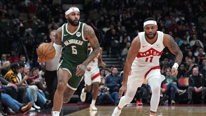 Jan 6, 2025; Toronto, Ontario, CAN; Milwaukee Bucks guard Gary Trent Jr. (5) dribbles the ball as Toronto Raptors forward Bruce Brown (11) defends during the second quarter at Scotiabank Arena. Mandatory Credit: Nick Turchiaro-Imagn Images Jan 6, 2025; Toronto, Ontario, CAN; Milwaukee Bucks guard Gary Trent Jr. (5) dribbles the ball as Toronto Raptors forward Bruce Brown (11) defends during the second quarter at Scotiabank Arena. Mandatory Credit: Nick Turchiaro-Imagn Images