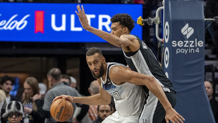 Minnesota Timberwolves center Rudy Gobert (27) backs toward the basket as San Antonio Spurs center Victor Wembanyama (1) plays defense in the second half at Target Center.