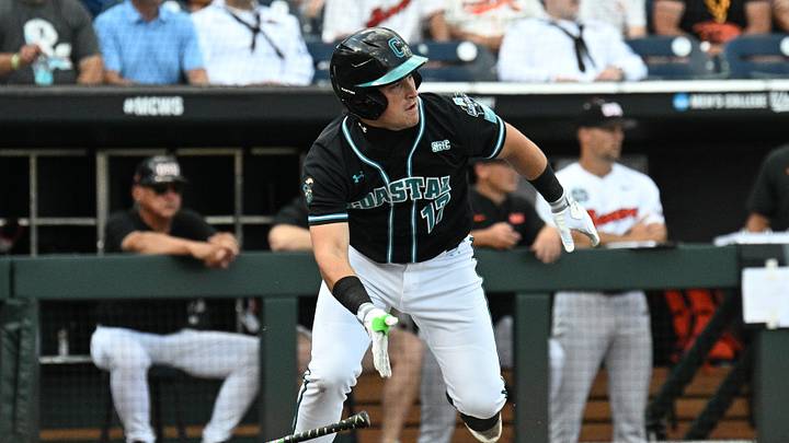 Jun 15, 2025; Omaha, Neb, USA; Coastal Carolina Chanticleers catcher Caden Bodine (17) reaches on an infield error by the Oregon State Beavers during the first inning at Charles Schwab Field. Mandatory Credit: Steven Branscombe-Imagn Images Jun 15, 2025; Omaha, Neb, USA; Coastal Carolina Chanticleers catcher Caden Bodine (17) reaches on an infield error by the Oregon State Beavers during the first inning at Charles Schwab Field. Mandatory Credit: Steven Branscombe-Imagn Images