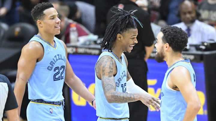Jan 4, 2022; Cleveland, Ohio, USA; Memphis Grizzlies guard Desmond Bane (22) and guard Ja Morant (12) and Memphis Grizzlies guard Tyus Jones (21) celebrate in the fourth quarter against the Cleveland Cavaliers at Rocket Mortgage FieldHouse. Mandatory Credit: David Richard-Imagn Images