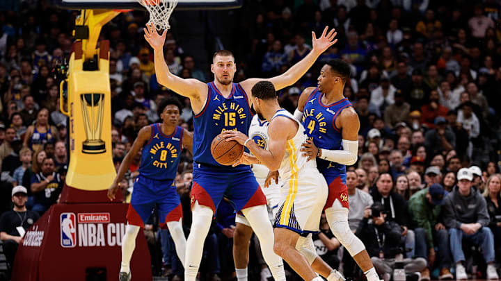 Golden State Warriors guard Stephen Curry (30) controls the ball under pressure from Denver Nuggets guard Russell Westbrook (4) and center Nikola Jokic (15) in the fourth quarter at Ball Arena. Mandatory Credit: Isaiah J. Downing-Imagn Images