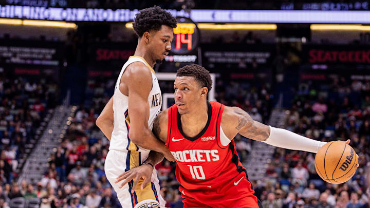 Dec 18, 2025; New Orleans, Louisiana, USA;  Houston Rockets forward Jabari Smith Jr. (10) dribbles against New Orleans Pelicans forward Trey Murphy III (25) during the second half at Smoothie King Center. Mandatory Credit: Stephen Lew-Imagn Images