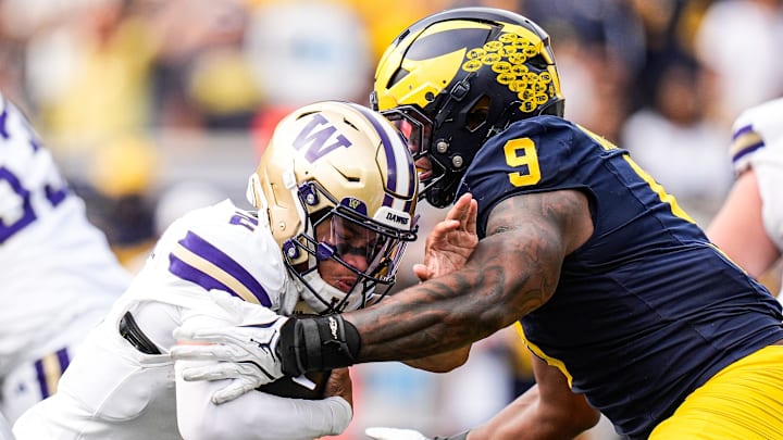 Michigan edge Cameron Brandt (9) tackles Washington quarterback Demond Williams Jr. (2) during the second half at Michigan Stadium in Ann Arbor on Saturday, Oct. 18, 2025.