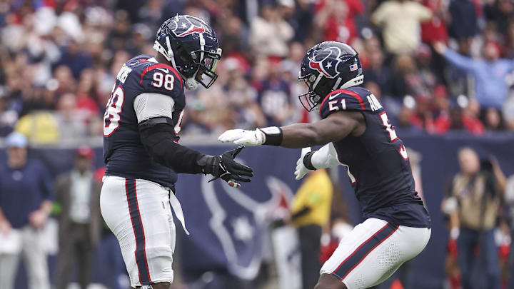 Dec 31, 2023; Houston, Texas, USA; Houston Texans defensive end Will Anderson Jr. (51) and defensive tackle Sheldon Rankins (98) react after a play during the game against the Tennessee Titans at NRG Stadium. Mandatory Credit: Troy Taormina-Imagn Images