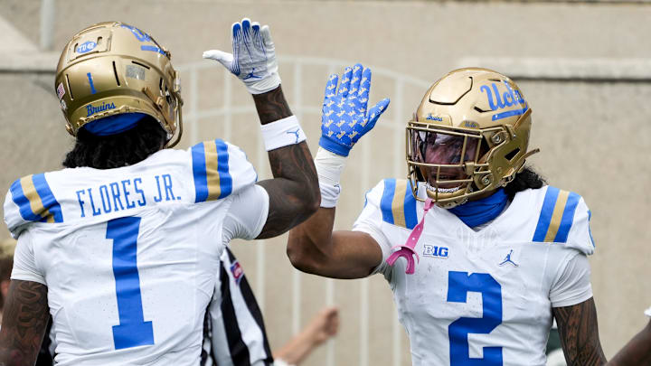 Oct 11, 2025; East Lansing, Michigan, USA; UCLA Bruins wide receiver Titus Mokiao-Atimalala (2) celebrates a touchdown with wide receiver Rico Flores Jr. (1) in the second quarter at Spartan Stadium. Mandatory Credit: Brendan Mullin-Imagn Images