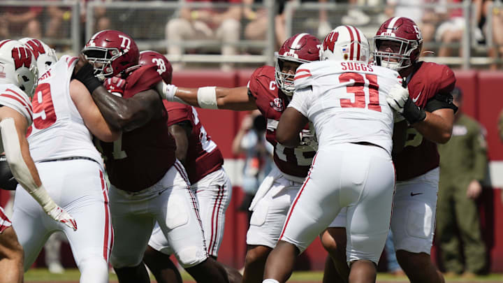 Sep 13, 2025; Tuscaloosa, Alabama, USA;  Alabama offensive lineman Jaeden Roberts (77), Alabama offensive lineman Parker Brailsford (72) and Alabama offensive lineman Geno VanDeMark (56) block against Wisconsin defensive lineman Parker Peterson (99) and Wisconsin defensive lineman Jay'viar Suggs (31) at Saban Field at Bryant-Denny Stadium.