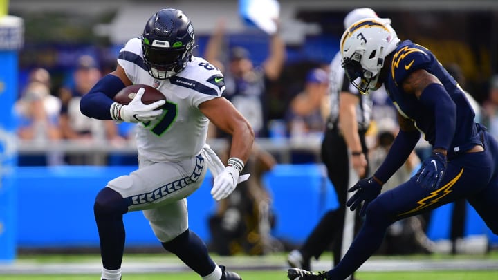 Oct 23, 2022; Inglewood, California, USA; Seattle Seahawks tight end Noah Fant (87) runs the ball against Los Angeles Chargers safety Derwin James Jr. (3) during the first half at SoFi Stadium.