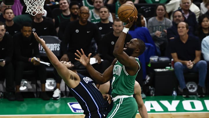 Boston Celtics guard Jaylen Brown (7) shoots over falling Orlando Magic guard Cory Joseph (10) during the first quarter of game two of the first round of the 2024 NBA Playoffs at TD Garden.