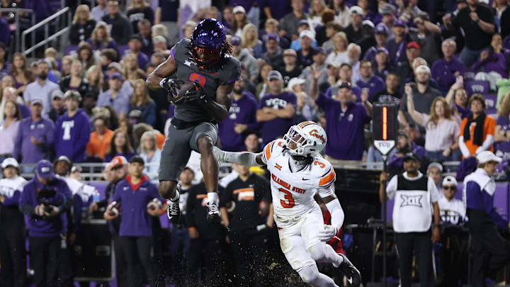Nov 9, 2024; Fort Worth, Texas, USA; TCU Horned Frogs wide receiver Savion Williams (3) catches a touchdown against Oklahoma State Cowboys cornerback Cam Smith (3) in the second quarter at Amon G. Carter Stadium. Mandatory Credit: Tim Heitman-Imagn Images