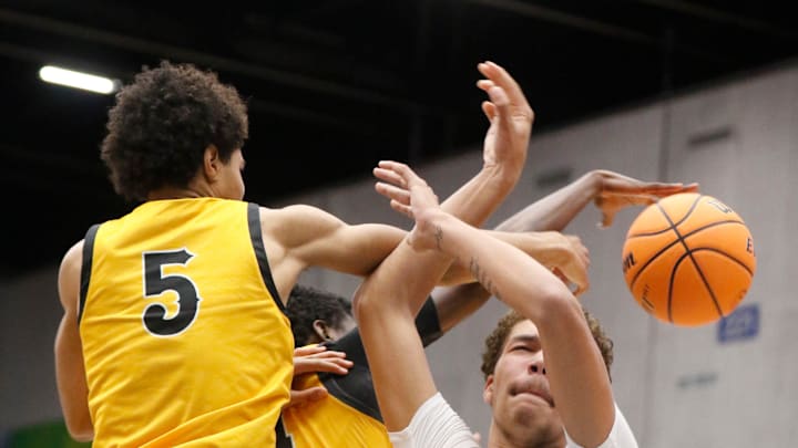 Mainland's DeAndre Newland (21) has his shot blocked by Blake's Joshua Lewis (5) and Joe Philon (1) in an FHSAA Class 5A boys basketball semifinal in Lakeland on Friday, March 6, 2024.