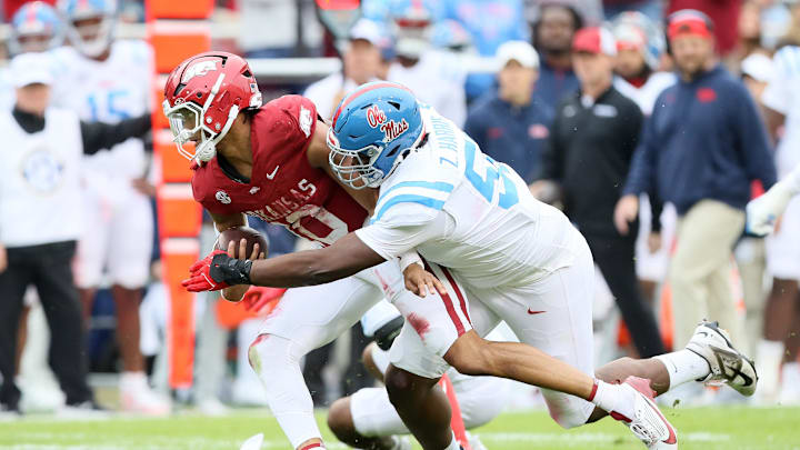 Nov 2, 2024; Fayetteville, Arkansas, USA; Arkansas Razorbacks quarterback Taylen Green (10) is injured on a tackle by Ole Miss Rebels nose tackle Zxavian Harris (51) during the first quarter at Donald W. Reynolds Razorback Stadium. Mandatory Credit: Nelson Chenault-Imagn Images Nov 2, 2024; Fayetteville, Arkansas, USA; Arkansas Razorbacks quarterback Taylen Green (10) is injured on a tackle by Ole Miss Rebels nose tackle Zxavian Harris (51) during the first quarter at Donald W. Reynolds Razorback Stadium. Mandatory Credit: Nelson Chenault-Imagn Images