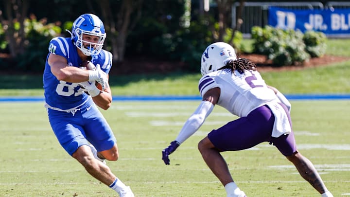 Sep 16, 2023; Durham, North Carolina, USA; Duke Blue Devils tight end Nicky Dalmolin (81) runs with the ball while Northwestern Wildcats defensive back Garnett Hollis Jr. (2) goes for the tackle during the first half at Wallace Wade Stadium. Mandatory Credit: Jaylynn Nash-Imagn Images