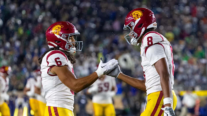 Oct 18, 2025; South Bend, Indiana, USA; Southern California Trojans wide receiver Ja'Kobi Lane (8) celebrates after scoring against the Notre Dame Fighting Irish with wide receiver Makai Lemon (6) during the second half at Notre Dame Stadium. Mandatory Credit: Michael Caterina-Imagn Images