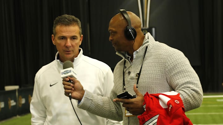 Jan 10, 2015; Arlington, TX, USA; Ohio State Buckeyes head coach Urban Meyer answers questions from Eddie George (right) during Media day at Dallas Convention Center. Mandatory Credit: Matthew Emmons-Imagn Images
