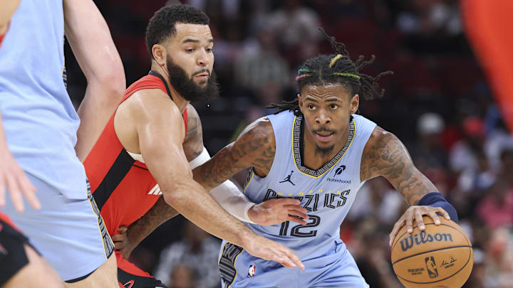 Oct 25, 2024; Houston, Texas, USA; Memphis Grizzlies guard Ja Morant (12) dribbles the ball as Houston Rockets guard Fred VanVleet (5) defends during the first quarter at Toyota Center. Mandatory Credit: Troy Taormina-Imagn Images
