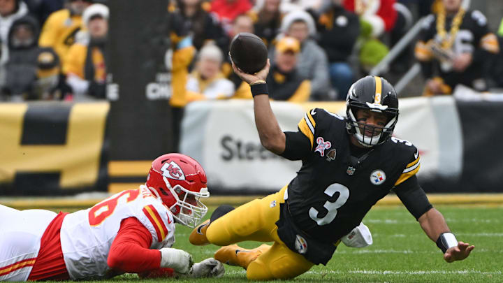 Dec 25, 2024; Pittsburgh, Pennsylvania, USA; A Kansas City Chiefs defensive end George Karlaftis (56) tackles Pittsburgh Steelers quarterback Russell Wilson (3) during the first quarter at Acrisure Stadium. Mandatory Credit: Barry Reeger-Imagn Images Dec 25, 2024; Pittsburgh, Pennsylvania, USA; A Kansas City Chiefs defensive end George Karlaftis (56) tackles Pittsburgh Steelers quarterback Russell Wilson (3) during the first quarter at Acrisure Stadium. Mandatory Credit: Barry Reeger-Imagn Images