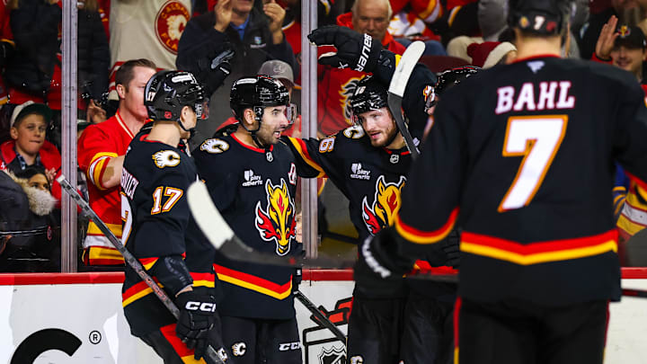 Dec 8, 2025; Calgary, Alberta, CAN; Calgary Flames center Nazem Kadri (91) celebrates his goal with teammates against the Buffalo Sabres during the second period at Scotiabank Saddledome. Mandatory Credit: Sergei Belski-Imagn Images Dec 8, 2025; Calgary, Alberta, CAN; Calgary Flames center Nazem Kadri (91) celebrates his goal with teammates against the Buffalo Sabres during the second period at Scotiabank Saddledome. Mandatory Credit: Sergei Belski-Imagn Images