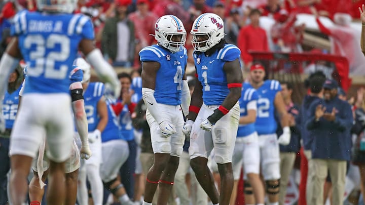 Nov 9, 2024; Oxford, Mississippi, USA; Mississippi Rebels linebacker Suntarine Perkins (4) reacts with defensive lineman Princely Umanmielen (1) after a defensive stop during the first half against the Georgia Bulldogs at Vaught-Hemingway Stadium. Mandatory Credit: Petre Thomas-Imagn Images