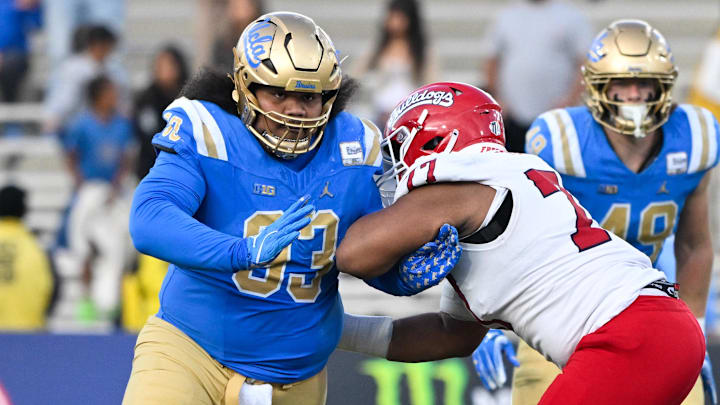 Nov 30, 2024; Pasadena, California, USA; UCLA Bruins defensive lineman Jay Toia (93) tangles with Fresno State Bulldogs offensive lineman Toreon Penright (77) during the fourth quarter at Rose Bowl. Mandatory Credit: Robert Hanashiro-Imagn Images Nov 30, 2024; Pasadena, California, USA; UCLA Bruins defensive lineman Jay Toia (93) tangles with Fresno State Bulldogs offensive lineman Toreon Penright (77) during the fourth quarter at Rose Bowl. Mandatory Credit: Robert Hanashiro-Imagn Images