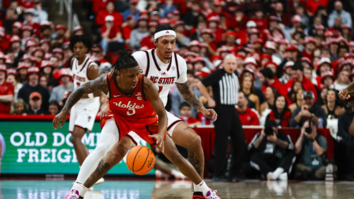 Feb 7, 2026; Raleigh, N.C.; Virginia Tech guard Ben Hammond (3) dribbles with the ball guarded by NC State forward Darrion Williams (1).