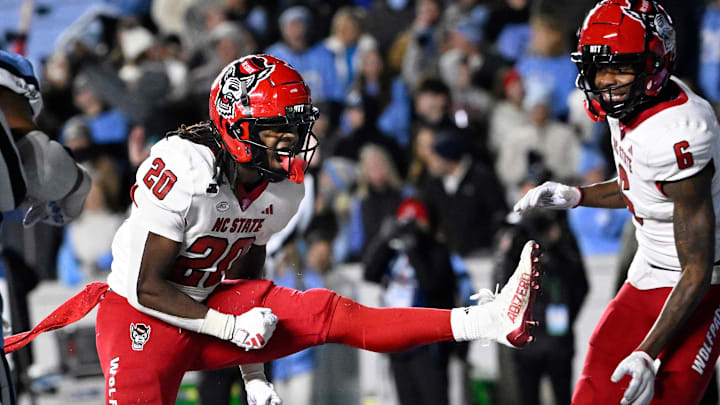 Nov 30, 2024; Chapel Hill, North Carolina, USA; North Carolina State Wolfpack running back Hollywood Smothers (20) reacts after scoring a touchdown with 25 seconds to go in the fourth quarter at Kenan Memorial Stadium. Mandatory Credit: Bob Donnan-Imagn Images