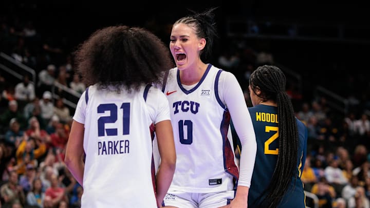 Mar 8, 2026; Kansas City, MO, USA; TCU Horned Frogs center Kennedy Basham (0) reacts after a play with TCU Horned Frogs guard Taliyah Parker (21) during the second half against the West Virginia Mountaineers at T-Mobile Center. Mandatory Credit: William Purnell-Imagn Images