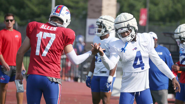 Bills quarterback Josh Allen works on the unique handshake with running back James Cook during day five.