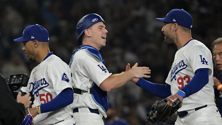 Los Angeles Dodgers catcher Will Smith (16) and center fielder Kevin Kiermaier (93) after clinching the National League West by defeating the San Diego Padres 7-2 at Dodger Stadium on Sept. 26, 2024.