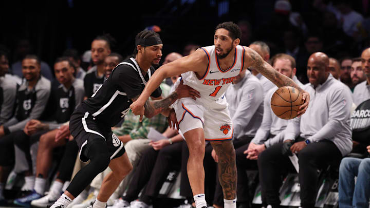 Apr 13, 2025; Brooklyn, New York, USA;  New York Knicks guard Cameron Payne (1) is guarded by Brooklyn Nets guard Keon Johnson (45) during the second half at Barclays Center. Mandatory Credit: Vincent Carchietta-Imagn Images