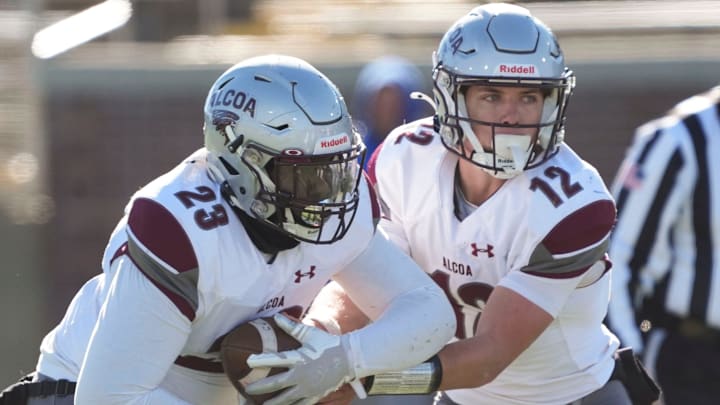 Alcoa's Eli Graf (12) hands off the ball to Jermon Bishop (23) during the TSSAA Class 3A high school football championship against Westview on Friday, Dec. 6, 2024, in Chattanooga, Tenn.