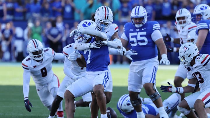 Oct 12, 2024; Provo, Utah, USA; Brigham Young Cougars running back Hinckley Ropati (7) fumbles the ball against the Arizona Wildcats during the fourth quarter at LaVell Edwards Stadium. Mandatory Credit: Rob Gray-Imagn Images