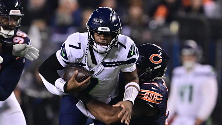 Dec 26, 2024; Chicago, Illinois, USA; Seattle Seahawks quarterback Geno Smith (7) is sacked by Chicago Bears defensive tackle Byron Cowart (93) during the second quarter at Soldier Field. Mandatory Credit: Daniel Bartel-Imagn Images
