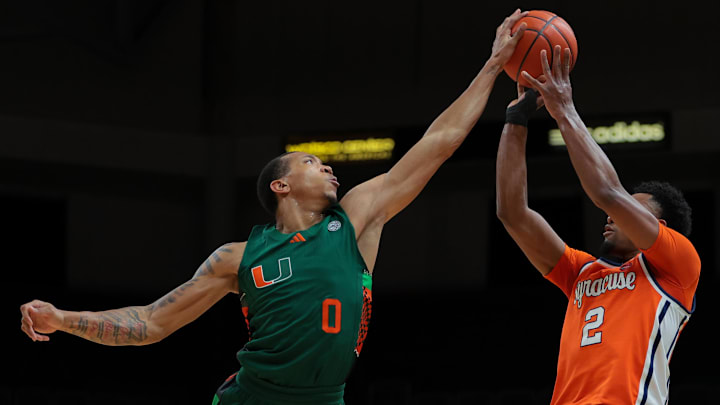 Feb 11, 2025; Coral Gables, Florida, USA; Miami Hurricanes guard Matthew Cleveland (0) blocks a shot against Syracuse Orange guard J.J. Starling (2) during the first half at Watsco Center. Mandatory Credit: Sam Navarro-Imagn Images Feb 11, 2025; Coral Gables, Florida, USA; Miami Hurricanes guard Matthew Cleveland (0) blocks a shot against Syracuse Orange guard J.J. Starling (2) during the first half at Watsco Center. Mandatory Credit: Sam Navarro-Imagn Images