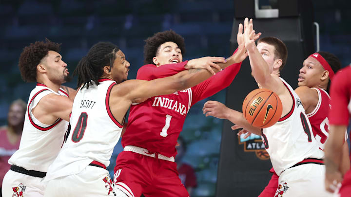 Indiana Hoosiers guard Myles Rice (1) battles for the ball with Louisville Cardinals forward Noah Waterman (93) and Louisville Cardinals forward James Scott (0) during the first half at the Atlantis Resort.