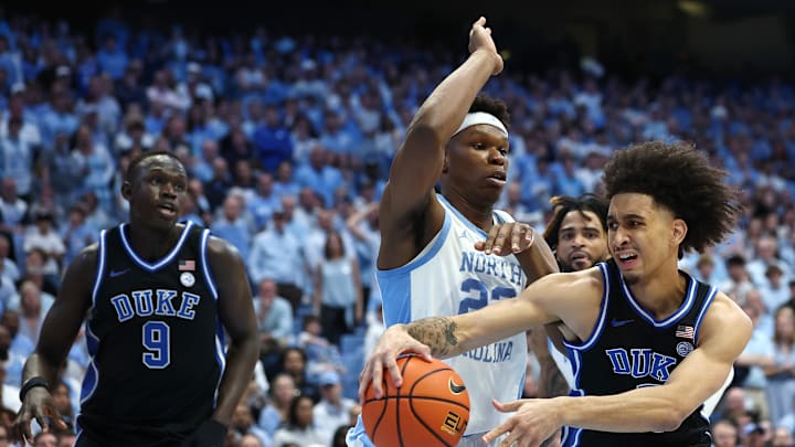 Duke v North Carolina; Duke basketball guard passes around UNC center Ven-Allen Lubin
