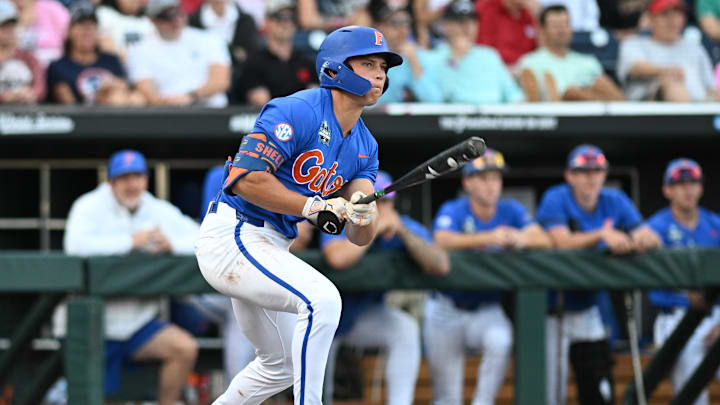 Jun 19, 2024; Omaha, NE, USA;  Florida Gators shortstop Colby Shelton (10) doubles against the Texas A&M Aggies during the second inning at Charles Schwab Field Omaha. Mandatory Credit: Steven Branscombe-Imagn Images